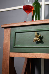 Green wooden drawer with a gold frog handle/ knob