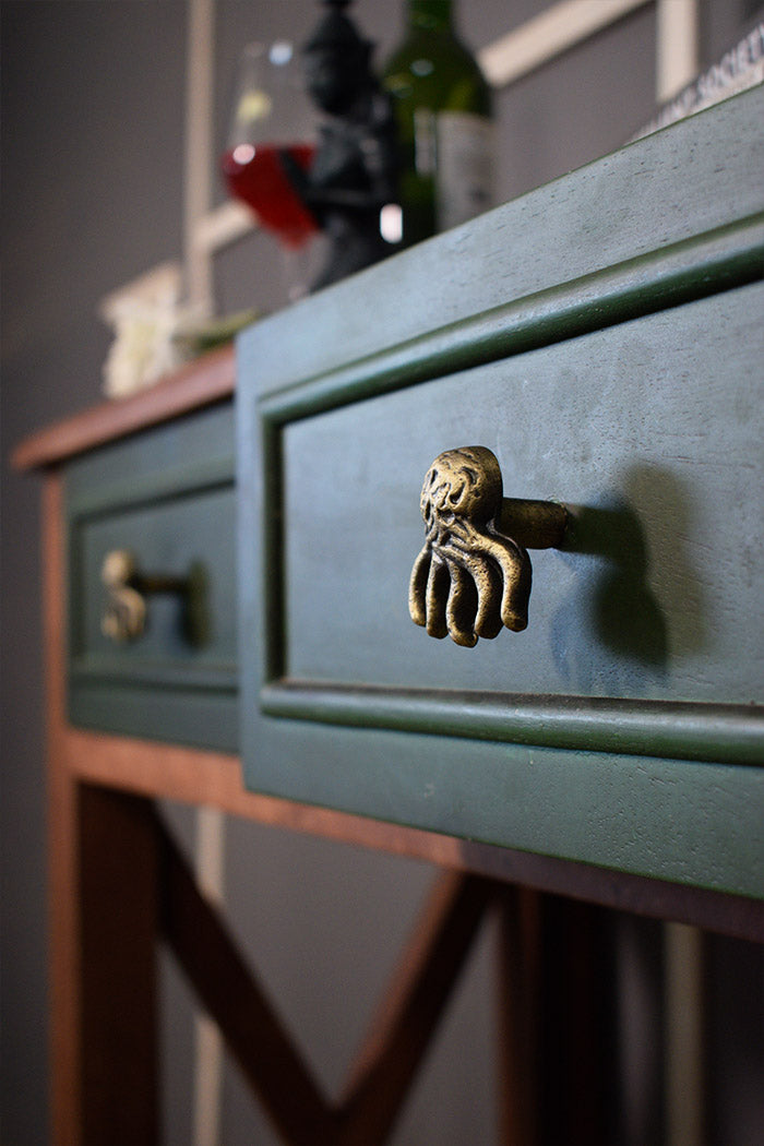 Green dresser with a unique octopus knob