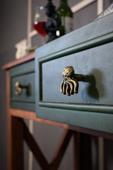 Green dresser with a unique octopus knob
