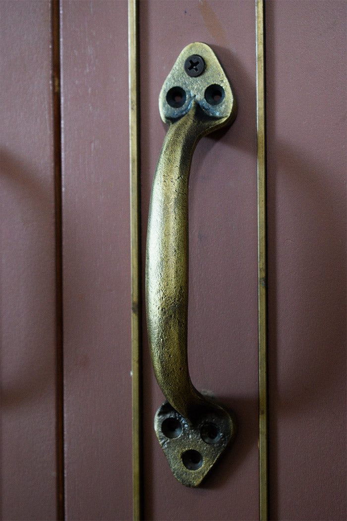 Bronze handle on a wooden door