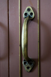 Bronze handle on a wooden door