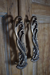 Decorative metal handles on a wooden door