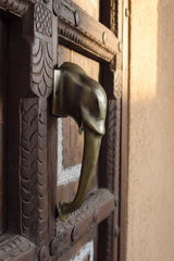 Decorative wooden door with an elephant head handle