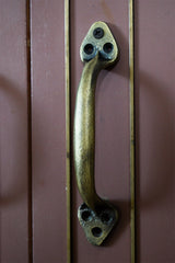 Bronze handle on a wooden door