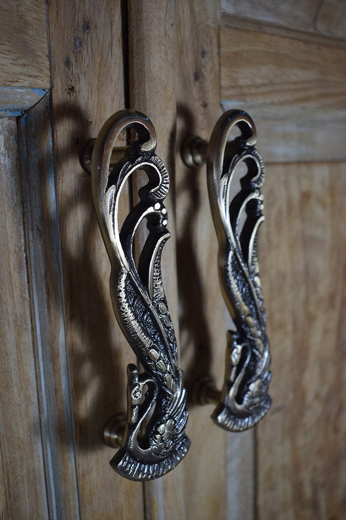 Decorative metal handles on a wooden door