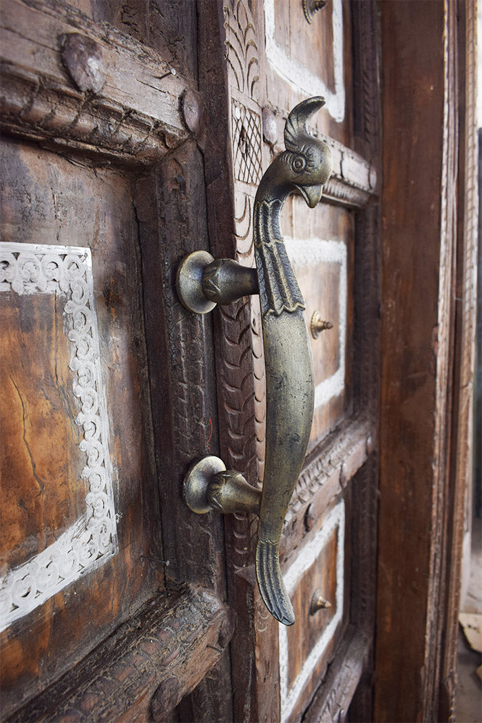 intricate carvings and a detailed peacock metal handle.
