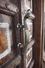 intricate carvings and a detailed peacock metal handle.